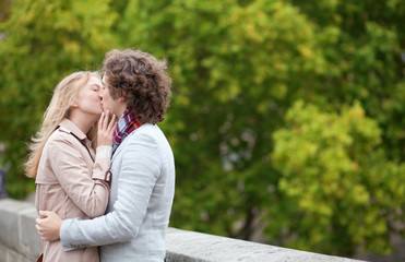 Fototapeta premium Romantic couple kissing outdoors