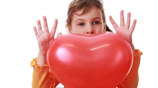 cute little girl hold big heart shaped red balloon