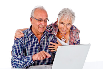 Seniors couple using a computer laptop