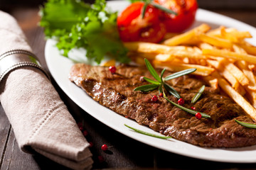 Grilled steak with french fries and rosemary