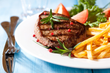 Grilled steak with french fries and salad