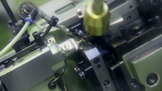 Automatic chain-bending machine in action, closeup view