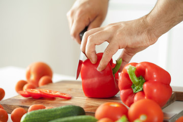man cutting vegetables for salad
