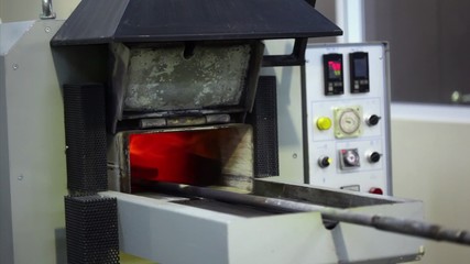 Man opens an annealing furnace, flame goes outside
