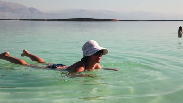 Close up of woman bathing in the Dead Sea.