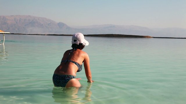 Close up of woman bathing in the Dead Sea.