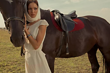 Foto op Canvas beautiful girl in a white gown with horse on nature © babkin
