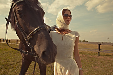 Obraz premium beautiful girl in a white gown with horse on nature