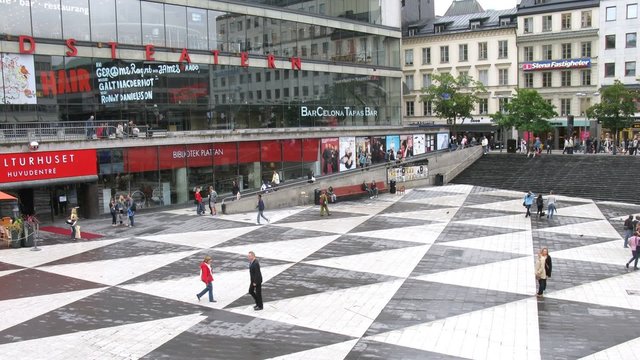 People pass in front of modern building