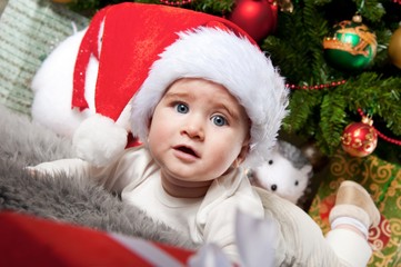 Little boy in Santa Claus hat.