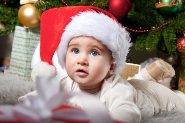 Little boy in Santa Claus hat.