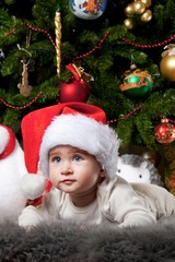 Little boy in Santa Claus hat.