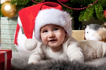Fototapeta na wymiar Little boy in Santa Claus hat.