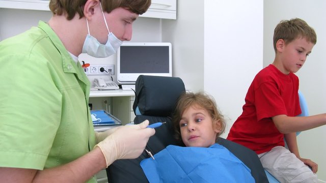 Boy assists doctor in high-tech dental clinic, time lapse