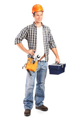 Fototapeta na wymiar Confident and smiling manual worker holding a wrench