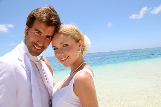 Portrait of just married couple on the beach