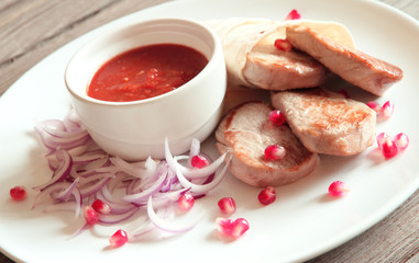 Roasted pork steaks on white plate