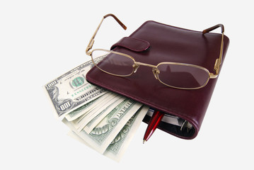 Business still-life. Dollars and the daily log