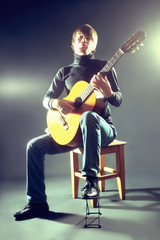 Fototapeta na wymiar Guitarist musician guitar acoustic playing.