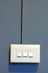 Tripple of Light Switch on gray Wall