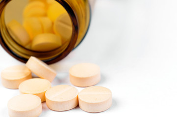 Pills and bottle on white isolated background