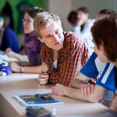 Fototapeta premium young, handsome college student sitting in a classroom