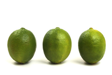 Three isolated limes on white background