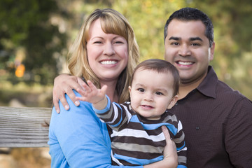 Obraz na płótnie Canvas Happy Mixed Race Ethnic Family Posing for A Portrait
