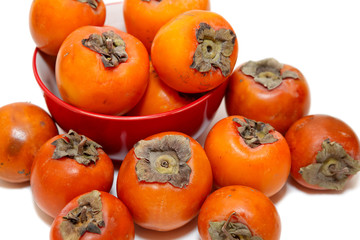 Red juicy persimmons isolated on white background
