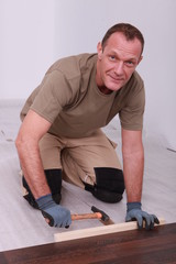 Man fitting laminate flooring