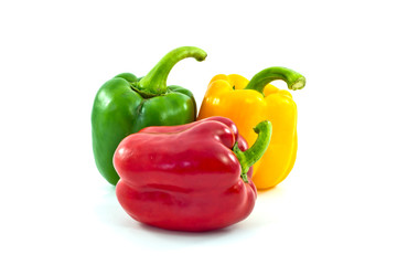 Red, yellow and green bell peppers isolated on the white backgro