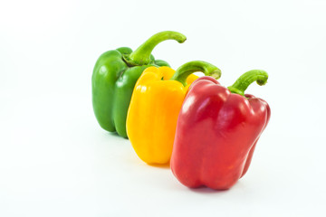 Red, yellow and green bell peppers isolated on the white backgro