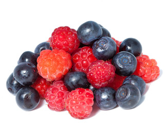 berries of raspberry and bilberry on white background