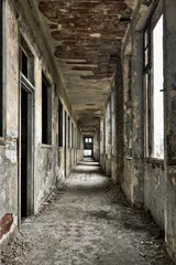Tuinposter Long empty corridor and doors in abandoned building © tobago77