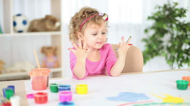 Girl with hand painted in colorful paints