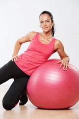 Fototapeta na wymiar Beautiful athlete woman with a fitness ball.