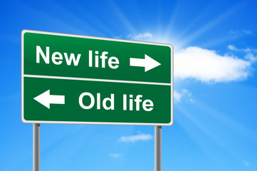 New life old life road sign on background clouds and sunburst.
