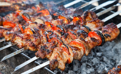 Juicy slices of meat with sauce prepare on fire