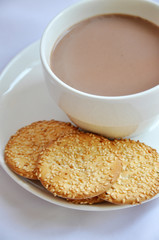 biscuit with cup of coffee and cream