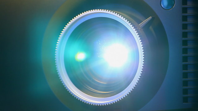 Front view of digital  film projector lens in action.