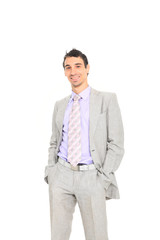 young business man standing with hands in pocket