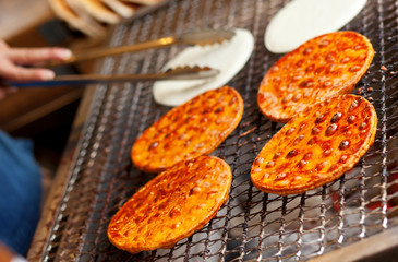 Preparing senbei, Japanese rice crackers
