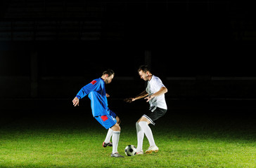 football players in action for the ball