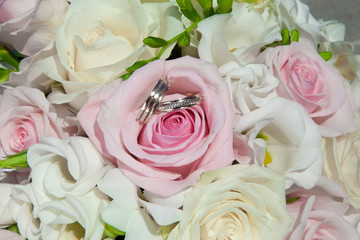 wedding rings on bouquet of bride