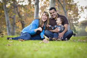 Fototapeta premium Happy Mixed Race Ethnic Family Playing with Bubbles In The Park