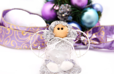 White christmas doll with balls and ribbon on the background