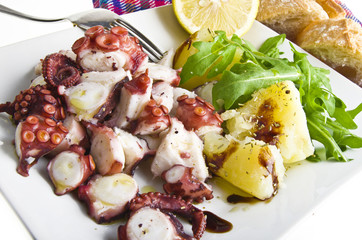 octopus salad with lemon slice and potatoes