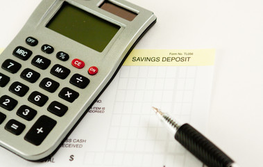 Calculator,pen with savings deposit slip