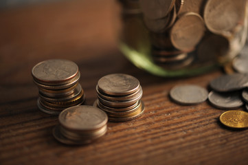 old coins on the wooden table, shallow dof