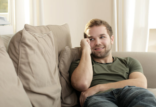 A young man relaxing on couch